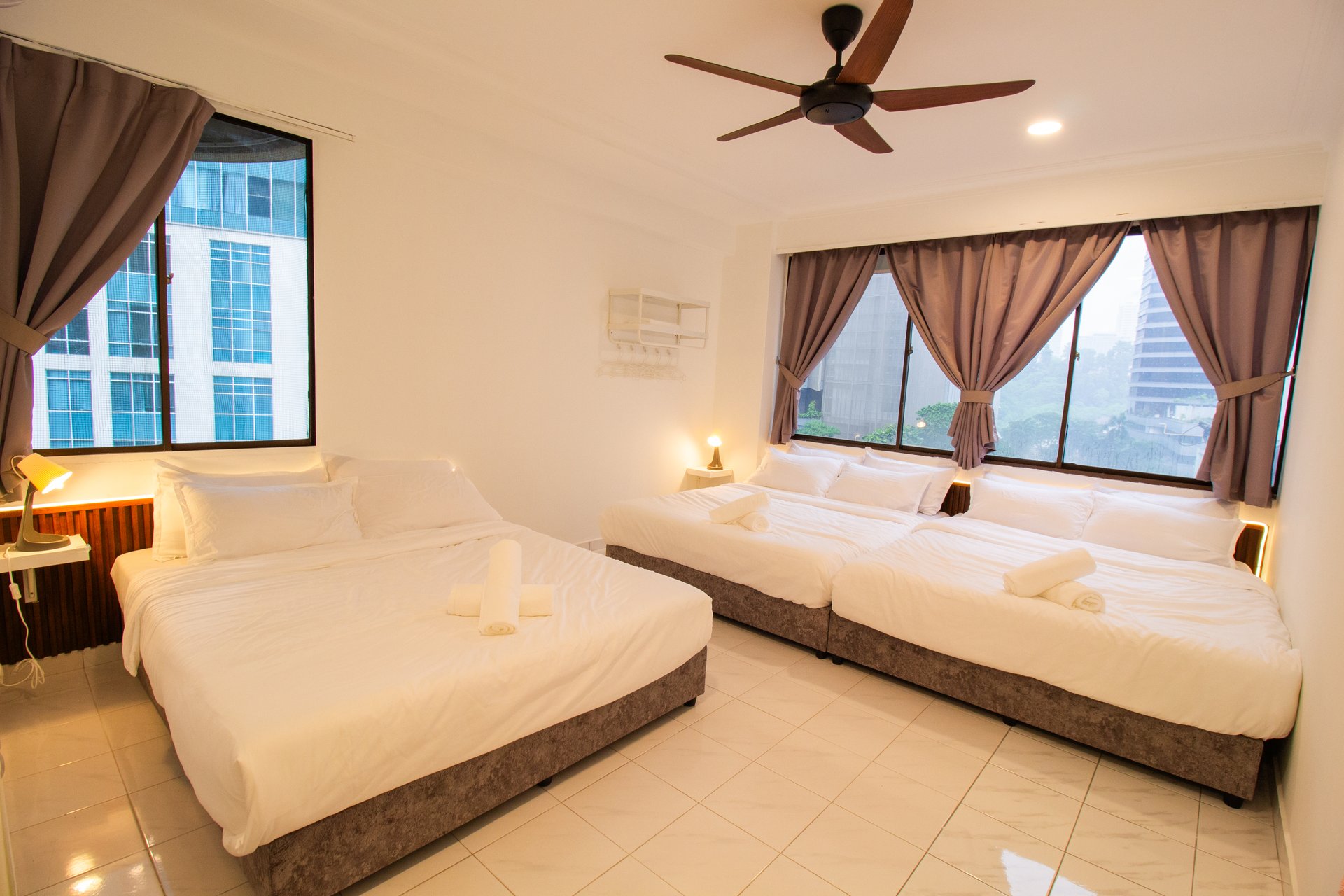 Downtown Condominium KL master bedroom prepared with three beds for group Airbnb stays