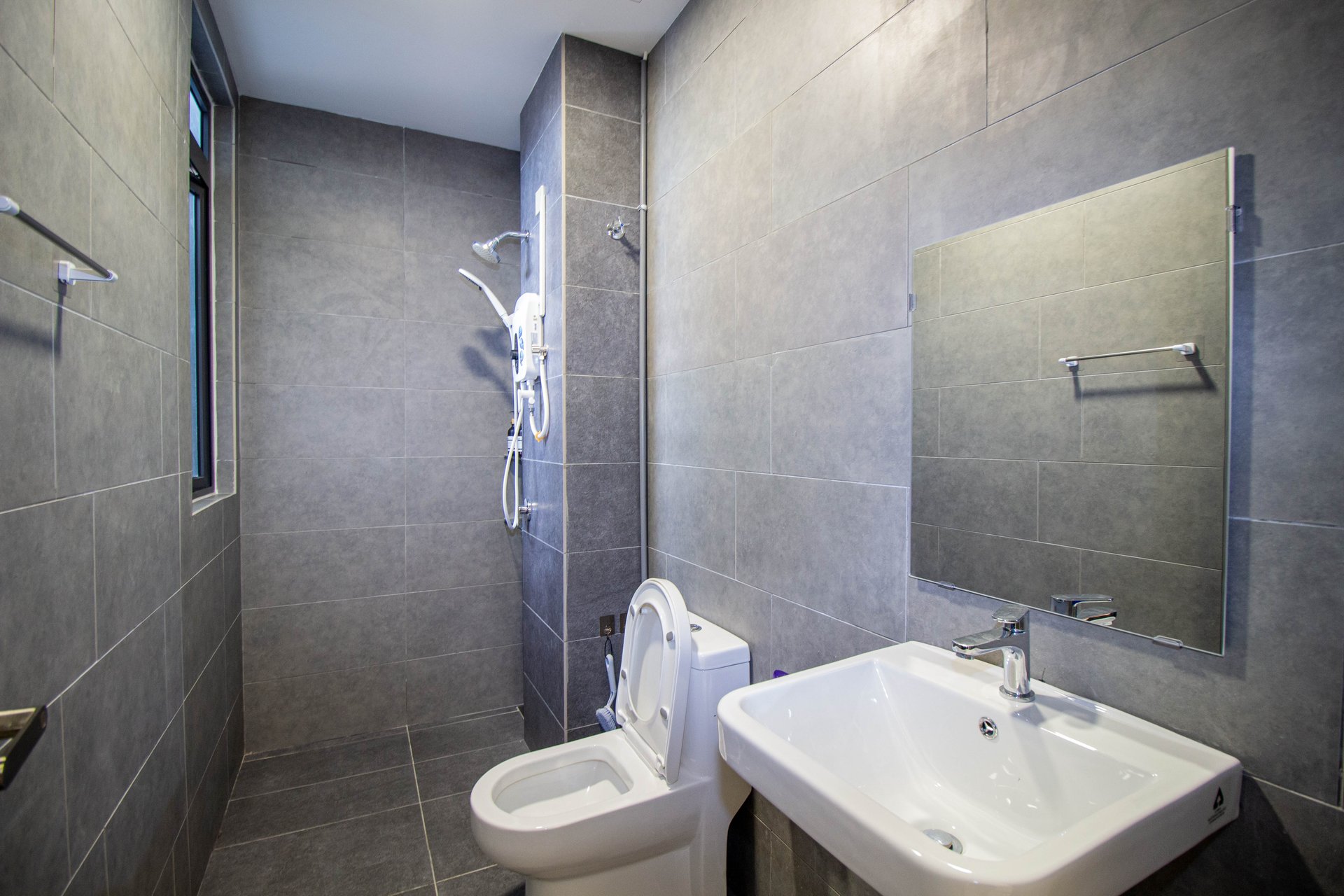 Bathroom at the Neu Suites stay with shower and basin